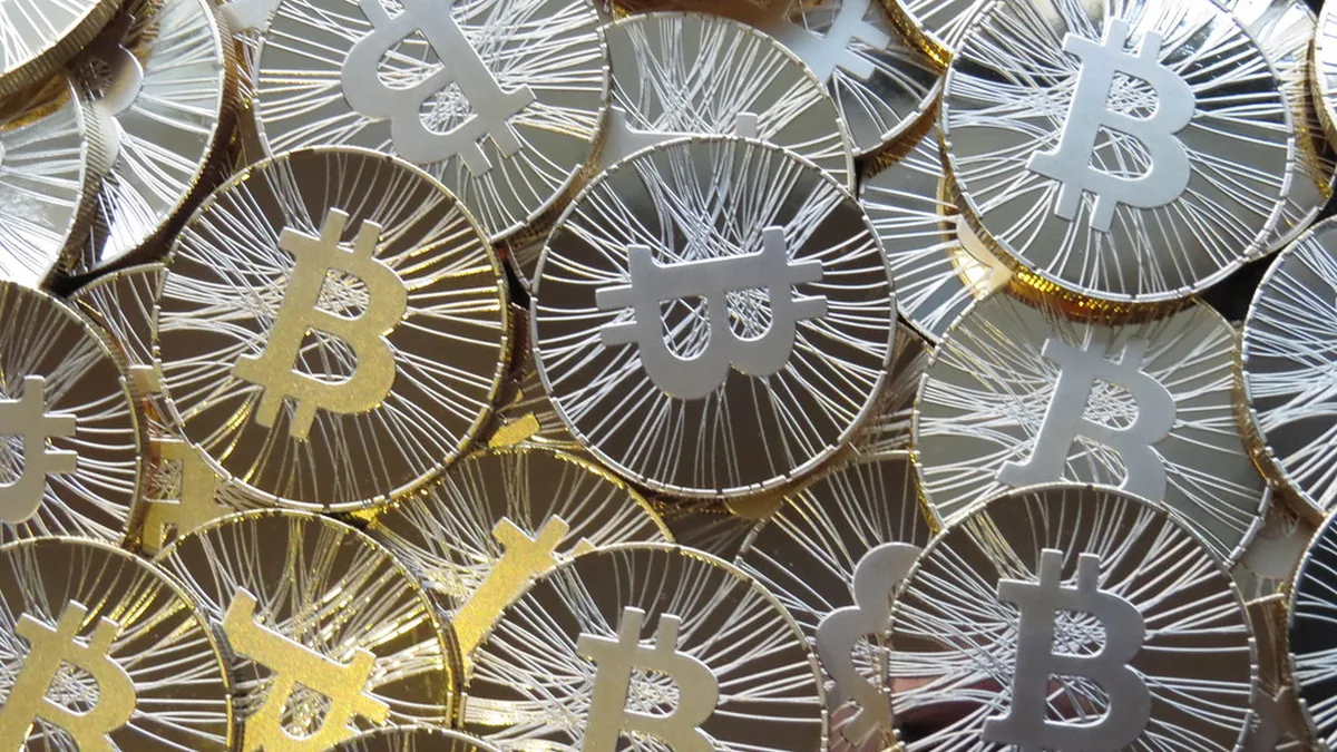 Pile of silver and gold physical bitcoin coins