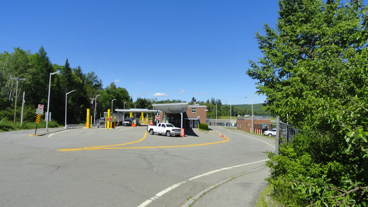 Canada-United States border crossing at Vanceboro, Maine, with inspection booths and a pickup truck